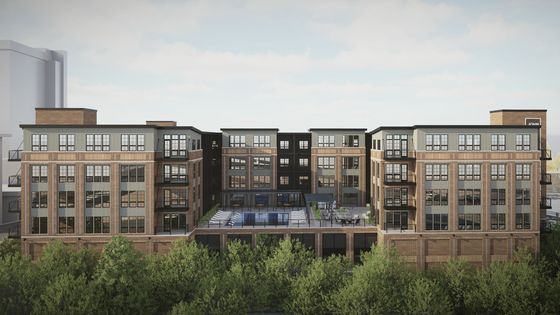 Modern multi-story building with brick facade and large windows, featuring a sleek rooftop terrace and inviting swimming pool, surrounded by lush greenery.