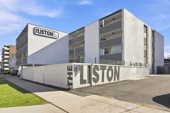 Modern apartment building 'The Liston' with stylish balconies and a sleek exterior, located at 30 South Emerson.