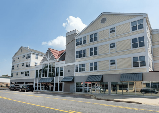 Contemporary apartment building with a stylish facade, featuring large windows and a welcoming entryway.