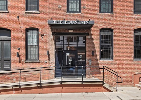 Charming brick exterior of The Fountain with large windows and welcoming entrance.