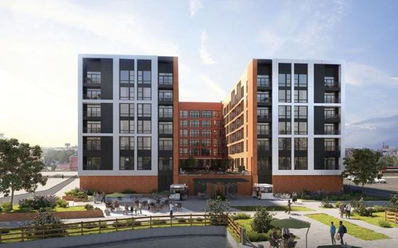 Contemporary residential building with modern design, featuring large windows and lush landscaping.