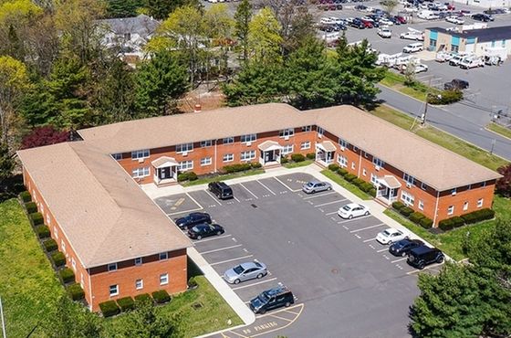 Aerial view Terrace Gardens Apartment complex with a central parking area surrounded by greenery.