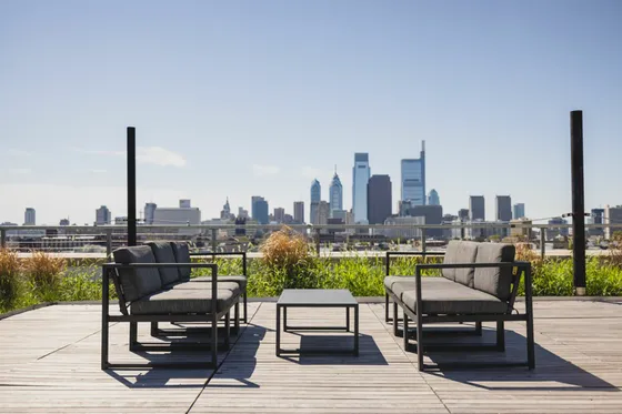 Chic rooftop lounge with modern seating and stunning city skyline views, perfect for relaxation and entertaining.