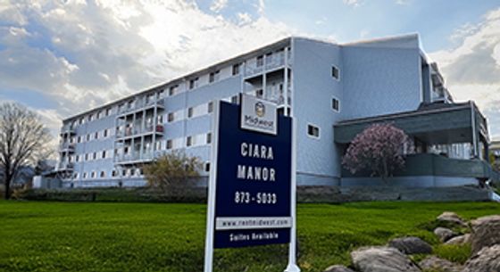 Modern apartment complex with lush green surroundings, featuring spacious units and a welcoming community vibe at Ciara Manor.