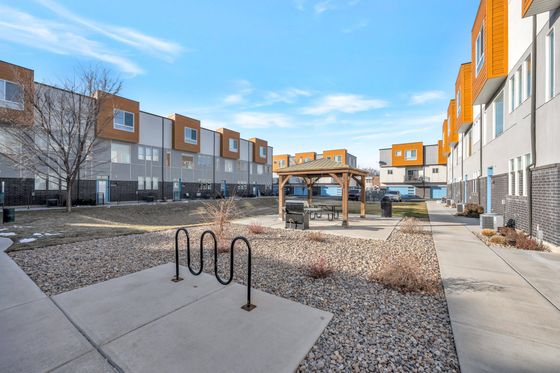 Beautiful two-story townhome building with a well-maintained garden and spacious balconies.