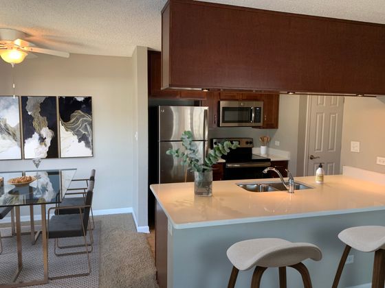 Chic open-concept kitchen and dining area with modern decor and stainless steel appliances.