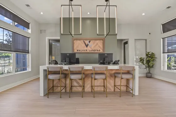 Elegant leasing office with modern design, comfortable seating, and abundant natural light at Walker Landing.