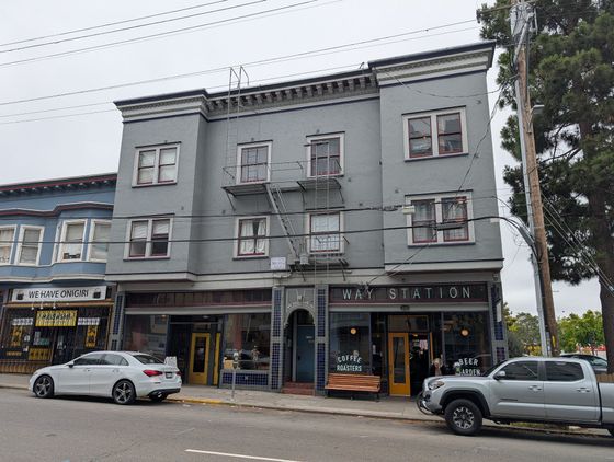 Charming urban building with inviting coffee shop and beer garden, perfect for city living with convenience and style.