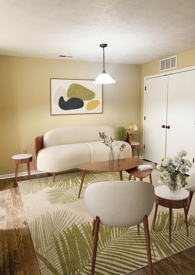 Bright and inviting living room with modern furnishings, chic abstract wall art, and a cozy earthy-toned rug complete with elegant lighting.