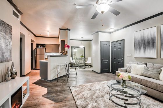 Contemporary open-concept living room and kitchen with sleek finishes, modern decor, and cozy ambiance.