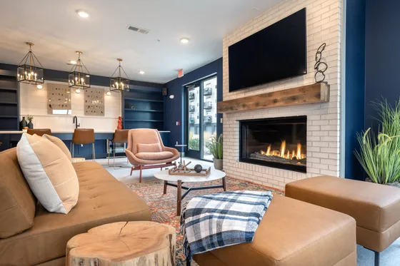Elegant living area with plush seating, warm fireplace, and modern lighting, ideal for cozy gatherings.