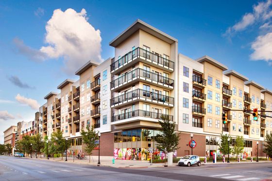 Modern apartment complex with stylish balconies and vibrant urban setting, perfect for contemporary living.