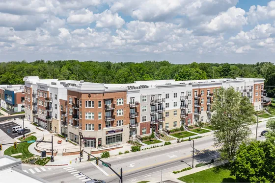 Charming modern apartment complex with elegant balconies, lush greenery, and a vibrant community atmosphere.