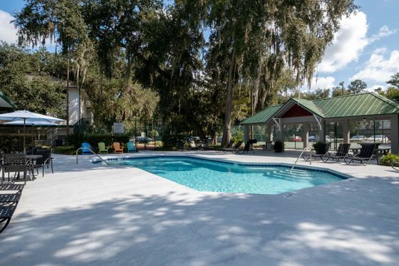 Pool with tennis court in background