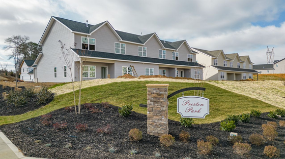 Charming modern townhouse community at Preston Park, showcasing beautiful architecture amidst lush landscaping.