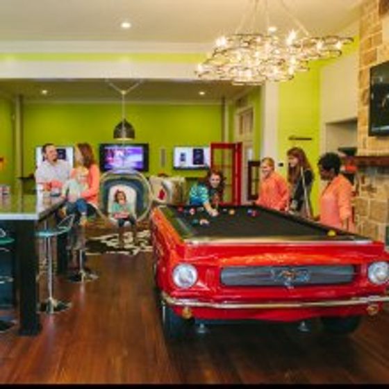 Fancy red car like pool table, Big screen TV, Bar Stools for seating