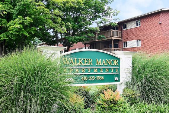 walker manor apartments green and gold community entry sign