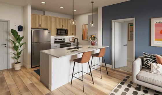 Modern kitchen with elegant wooden cabinets, sleek stainless steel appliances, stylish pendant lighting, and a chic breakfast bar with seating for two.