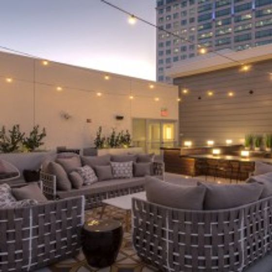 Outdoor patio space with plush seating and overhead lights