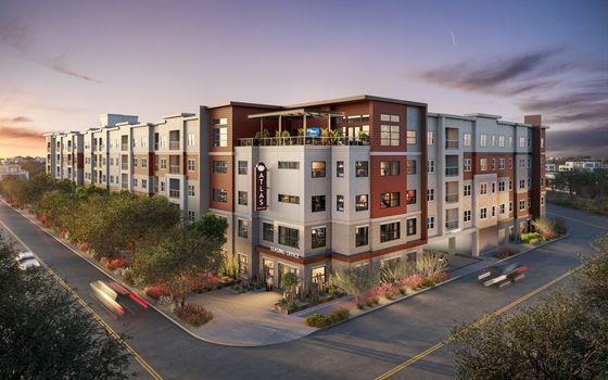 Elegant multi-story apartment building in a vibrant urban setting, featuring modern architecture and lush landscaping at sunset.