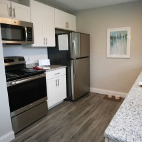 Ridgeview Apartments, interior, kitchen, wood floor, stainless steel appliances, white cabinets, stove/oven, microwave, refrigerator