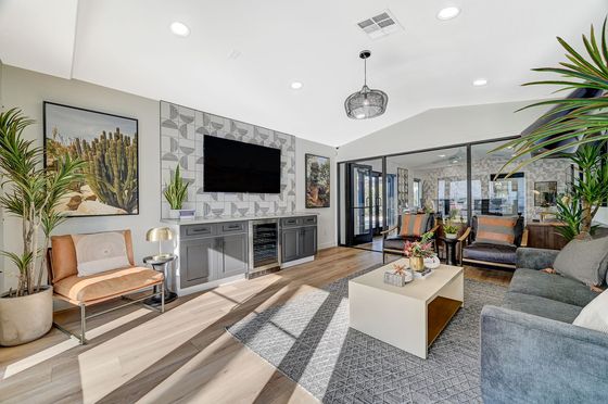 Contemporary living room with stylish decor, featuring elegant furniture, modern lighting, and lush plants, perfect for relaxation and entertainment.
