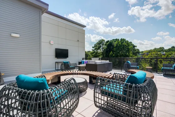 Outdoor lounge and patio at Union Chapel Hill apartments in Chapel Hill, NC, featuring modern seating and trees.