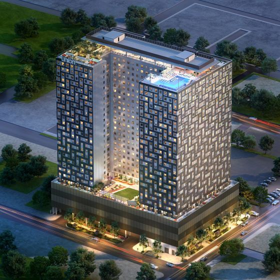 Union on 24th apartment building lit up at dusk showcasing the rooftop pool in Austin, TX.