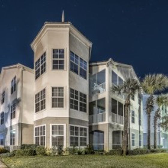 Avana Westchase, exterior, three story tan building, palm trees