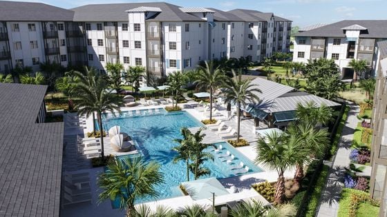 Rendering of beautiful pool courtyard with palm trees and soft seating