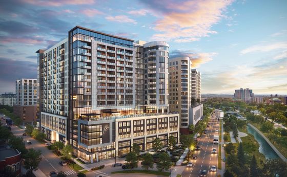Luxurious high-rise apartment building overlooking a tree-lined street and picturesque river, offering modern living with stunning views.