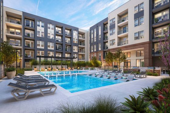Luxurious apartment complex featuring a stunning outdoor pool, modern lounging chairs, and lush landscaping, perfect for relaxation and leisure.