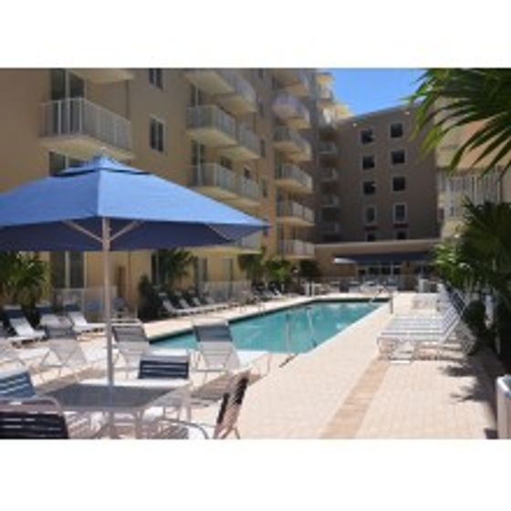 Miami Riverfront Residences, exterior, swimming pool, picnic table with umbrella, balconies, lounge chairs