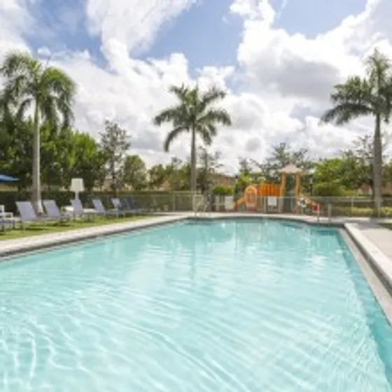 Gables 37 Grand, exterior, sparkling blue pool, palm trees