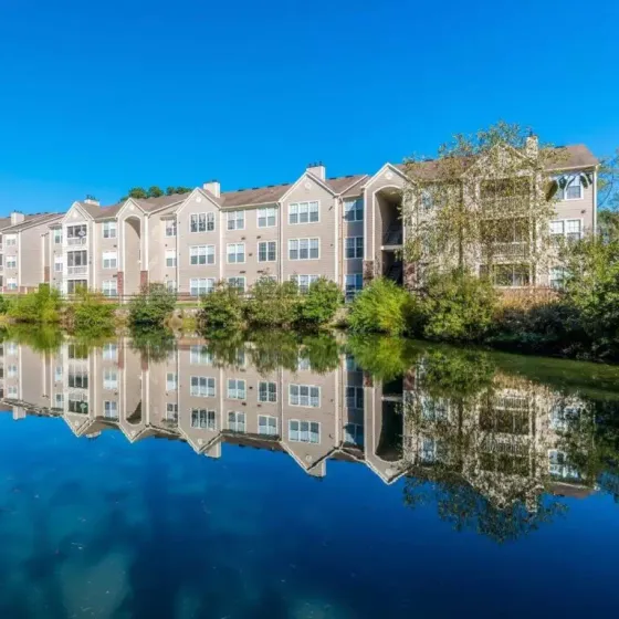 Apartment community at Advenir at Adams Farm with a peaceful lake view.