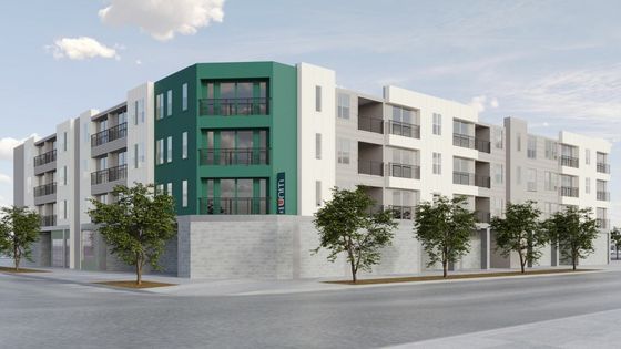 Contemporary multi-story apartment building with sleek green and white design.
