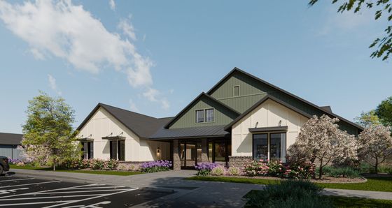 Charming suburban residence with modern architectural design, lush landscaping, and vibrant flowering bushes in a peaceful neighborhood setting.