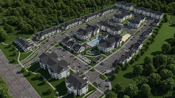 Aerial view of a serene apartment complex featuring modern buildings, a central swimming pool, ample parking, and lush green surroundings.