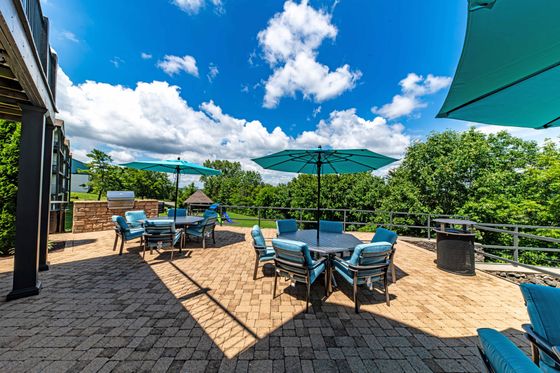 Charming patio with blue parasols, seating, and scenic views.
