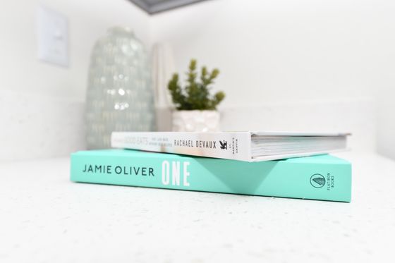 Elegant kitchen counter adorned with stylish books and a chic decorative plant.