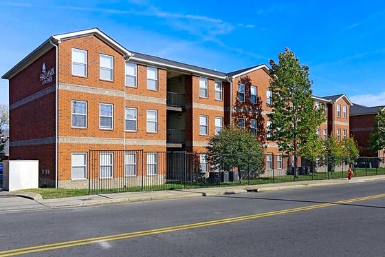 Charming brick apartment complex nestled in a serene neighborhood, showcasing modern architecture with abundant natural light.
