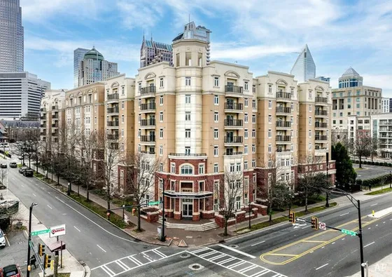 Elegant urban apartment building with classic architecture, nestled in a lively city center, perfect for modern living.