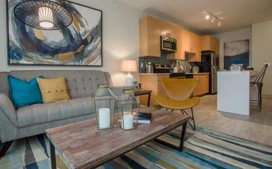 Modern open-concept apartment with stylish living area, chic decor, and a sleek kitchen offering contemporary amenities.