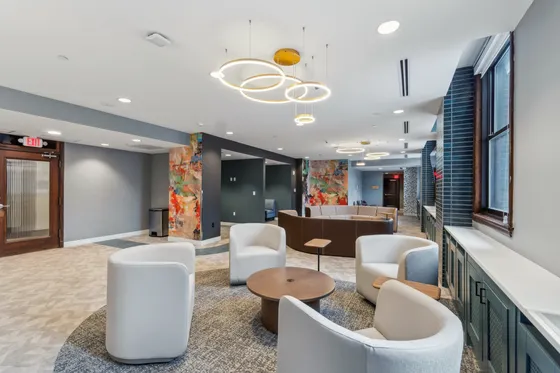 Modern and vibrant apartment lounge with stylish seating, contemporary lighting, and artistic decor. Perfect space for relaxation and social gatherings.