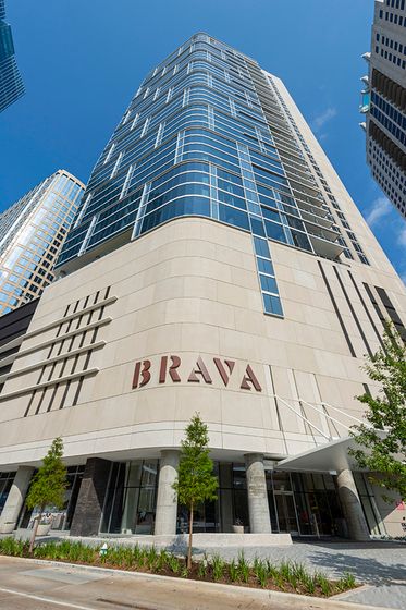Stunning modern high-rise with sleek glass architecture and elegant design at Brava, offering urban luxury living.