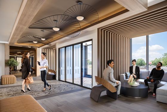 Contemporary lobby with elegant wood accents, stylish seating, and large windows offering abundant natural light.