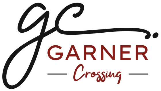 Elegant Garner Crossing logo in black and red, featuring a stylish script design.