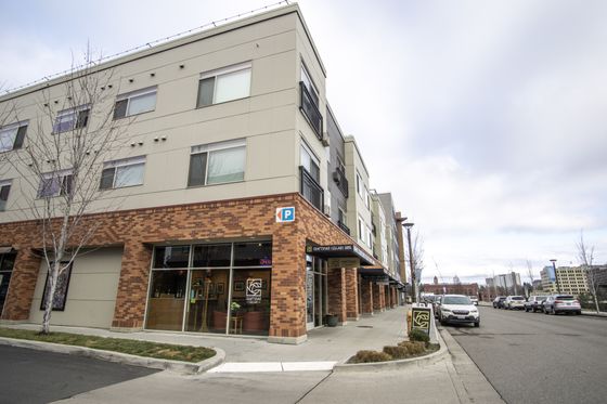 Contemporary apartment building with stylish brick facade and large windows.