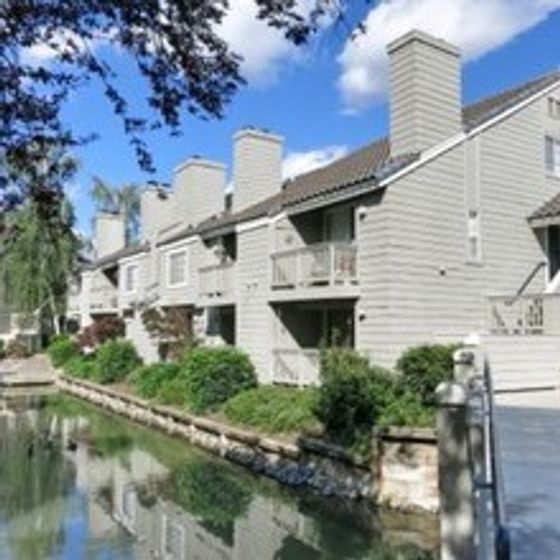 Landing at Riverlake Building Exterior with Back Patio View and Lagoon