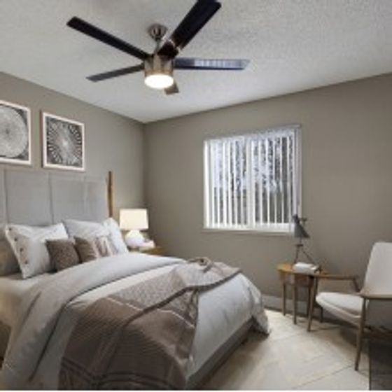 Master bedroom, fully furnished, showing lighted ceiling fan and window with vertical blinds.